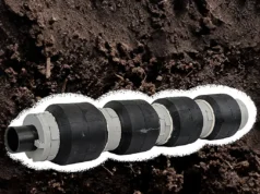 Robots inspirados en lombrices para la instalación de líneas eléctricas subterráneas Robot cilíndrico con cuatro anillos gruesos espaciados uniformemente, diseñado para imitar el movimiento de una lombriz de tierra. La estructura combina materiales en tonos negros y grises, con un fondo de suelo terroso que refuerza su propósito de exploración subterránea.