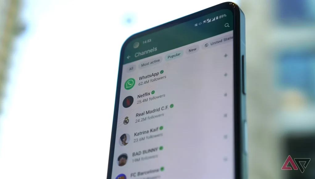 Pantalla de un smartphone mostrando la sección de Canales de WhatsApp, con canales populares como WhatsApp, Netflix y Real Madrid C.F., mientras el fondo exterior aparece desenfocado.
