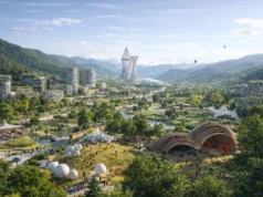 Un multimillonario quiere reinventar los Apalaches con una ambiciosa ciudad utópica Vista panorámica de una ciudad futurista integrada en un valle montañoso de los Apalaches, con edificios modernos rodeados de amplias zonas verdes, parques y senderos peatonales. En el centro destaca una torre arquitectónica vanguardista, mientras personas caminan por espacios públicos, pabellones orgánicos y áreas recreativas, con colinas boscosas al fondo y un cielo despejado que refuerza la idea de sostenibilidad y vida comunitaria.